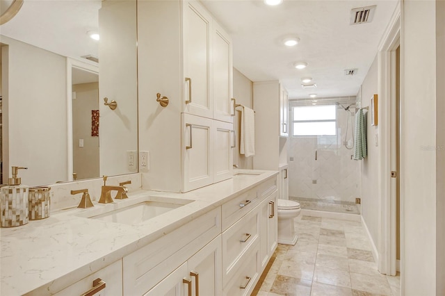 bathroom with vanity, a shower with shower door, toilet, and tile patterned floors