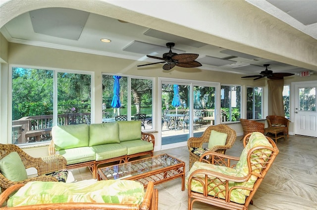 sunroom featuring ceiling fan