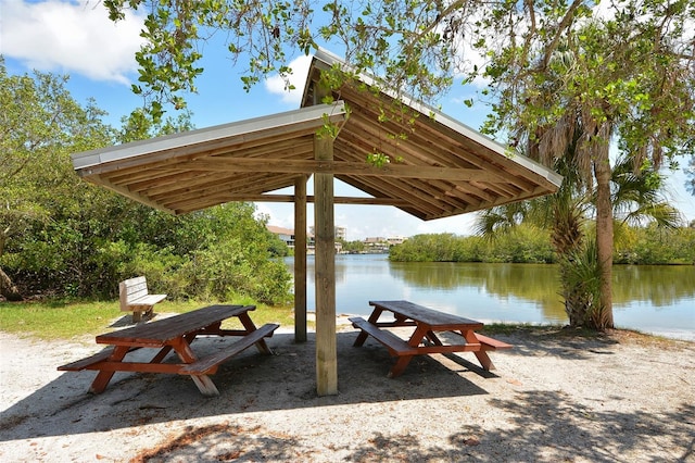 surrounding community with a water view and a gazebo