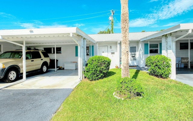 view of front facade with a front yard and a carport