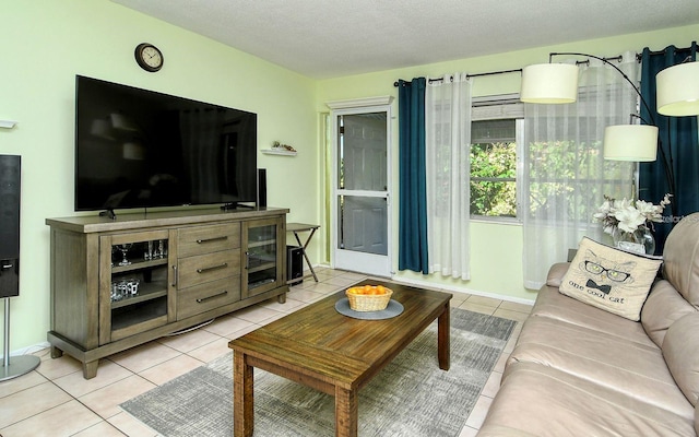 tiled living room featuring a textured ceiling