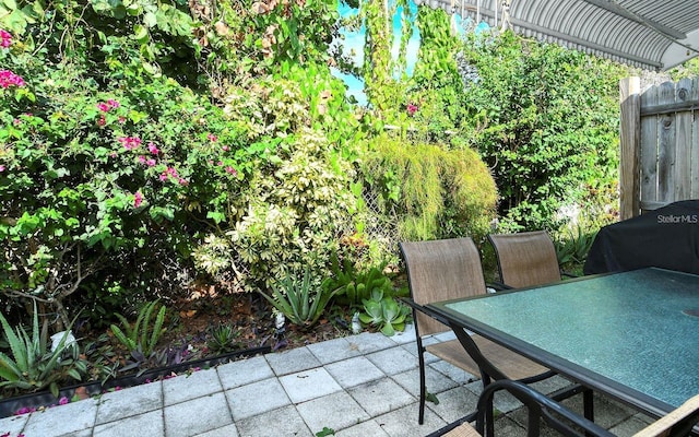 view of patio featuring a grill