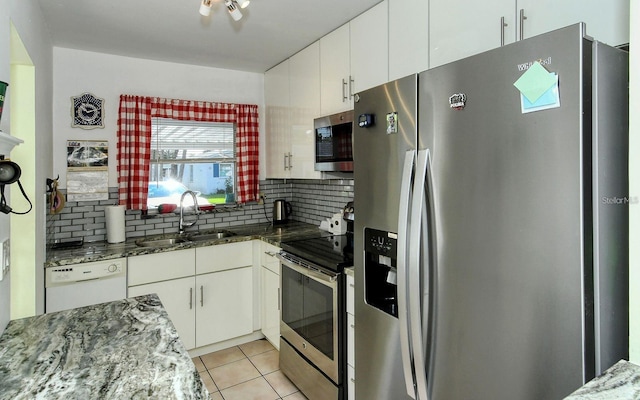 kitchen with white cabinetry, appliances with stainless steel finishes, sink, and decorative backsplash