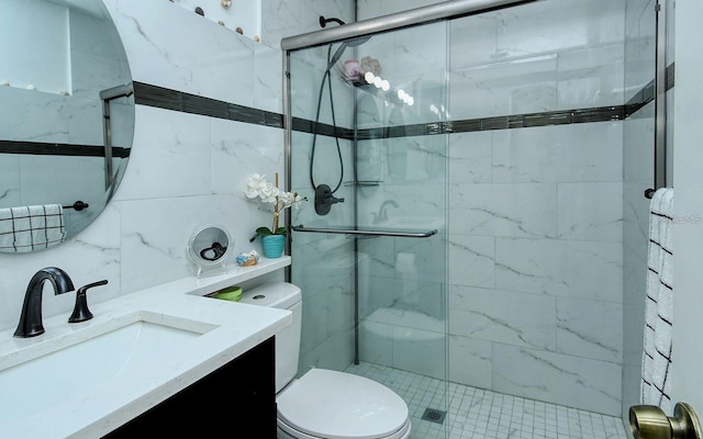 bathroom with tile walls, vanity, toilet, and walk in shower