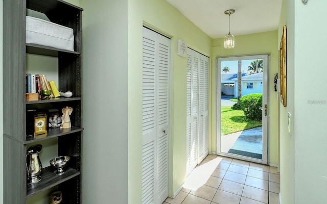 doorway to outside with light tile patterned floors