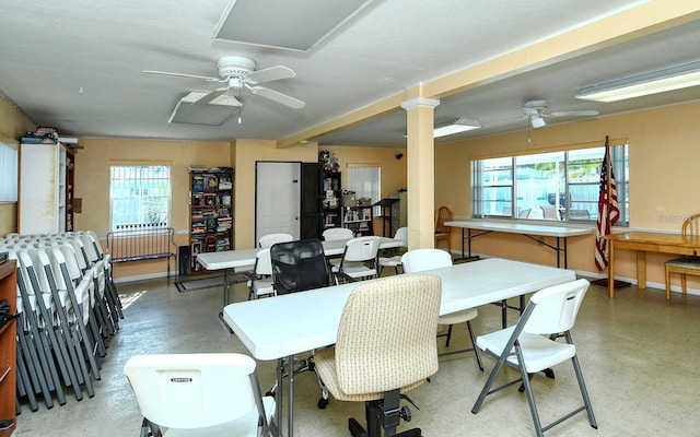 dining space featuring ceiling fan, decorative columns, and a wealth of natural light