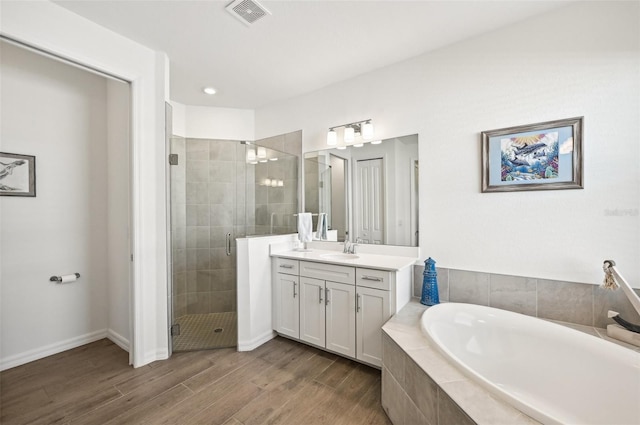 bathroom featuring vanity, shower with separate bathtub, and hardwood / wood-style flooring