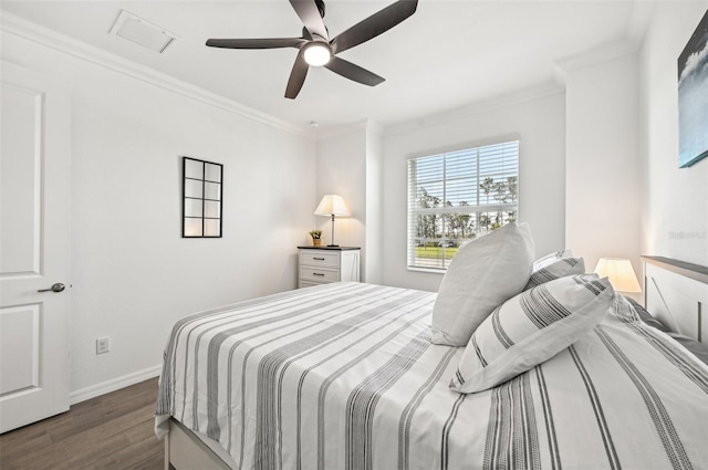 bedroom featuring crown molding, dark hardwood / wood-style floors, and ceiling fan