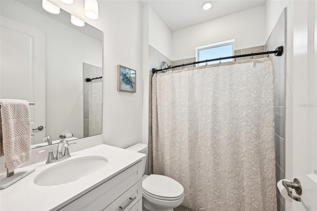 bathroom featuring vanity, a shower with shower curtain, and toilet