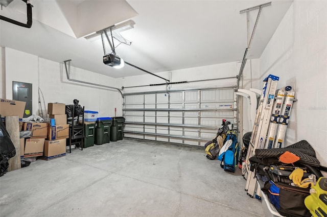 garage featuring electric panel and a garage door opener