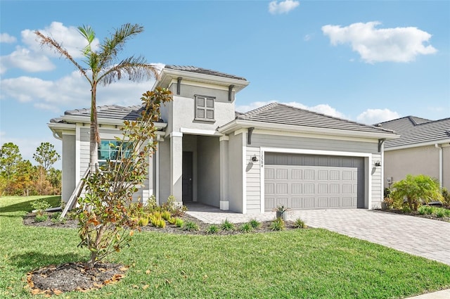 view of front of home with a front yard and a garage