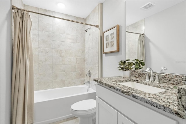 full bathroom with vanity, shower / tub combo, and toilet