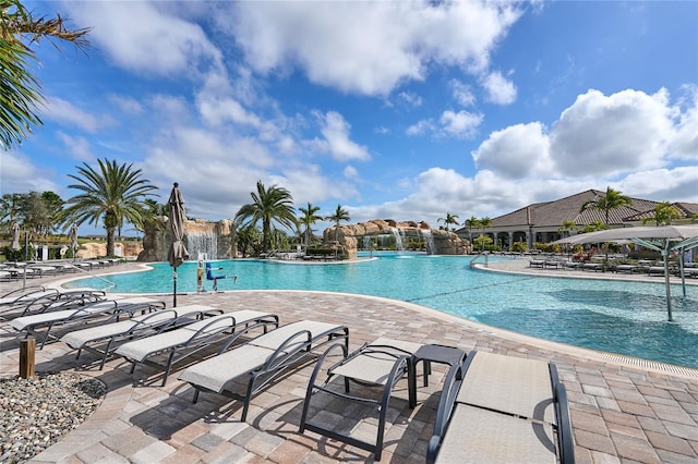 view of pool with a patio and pool water feature