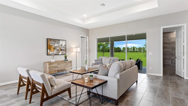 living room featuring a raised ceiling