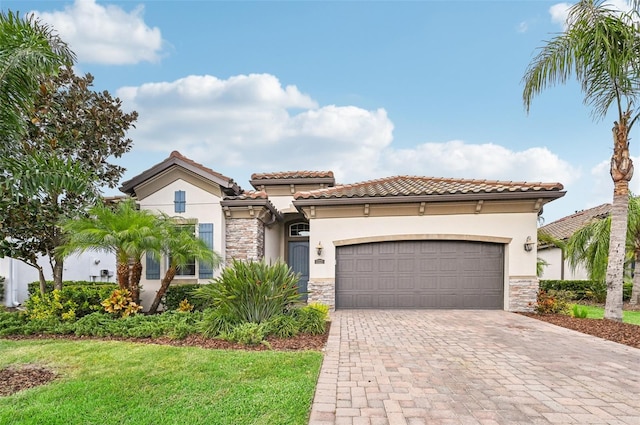 mediterranean / spanish-style home with a front yard and a garage