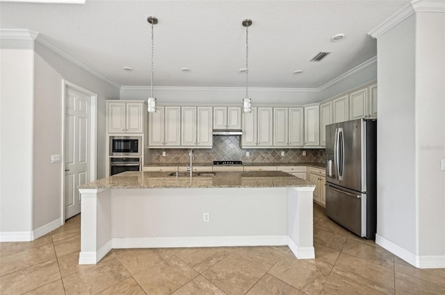 kitchen with stone countertops, an island with sink, stainless steel appliances, sink, and pendant lighting