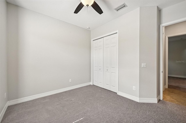 unfurnished bedroom featuring carpet, a closet, and ceiling fan