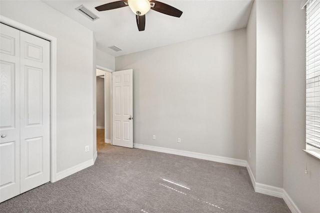 unfurnished bedroom featuring carpet flooring, a closet, and ceiling fan