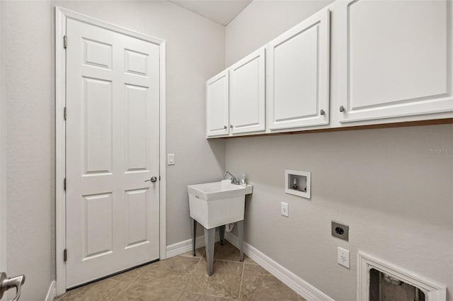 washroom with light tile patterned floors, electric dryer hookup, washer hookup, and cabinets