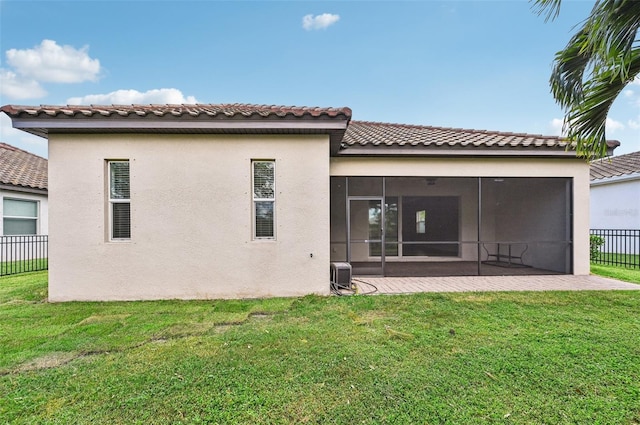 back of house with a patio, a yard, central air condition unit, and a sunroom