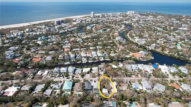 bird's eye view featuring a water view and a view of the beach