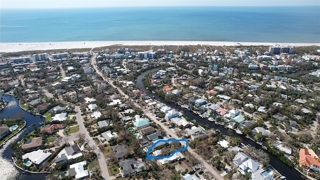 bird's eye view featuring a water view and a beach view