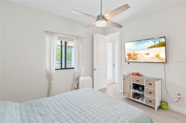 bedroom featuring light wood-type flooring and ceiling fan