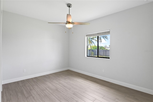 spare room featuring light hardwood / wood-style floors and ceiling fan