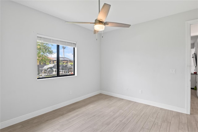 empty room with light wood-type flooring and ceiling fan