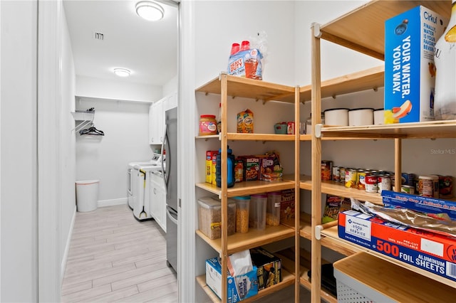 pantry featuring separate washer and dryer