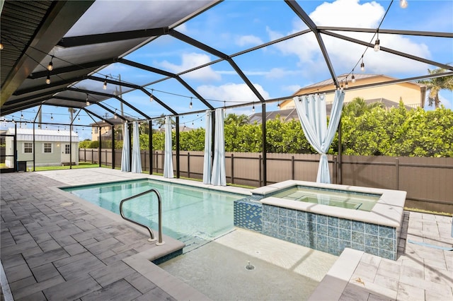 view of pool with an in ground hot tub, a patio, and a lanai