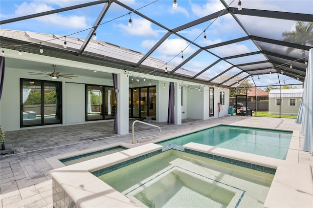 view of pool featuring a patio, a lanai, an in ground hot tub, and ceiling fan