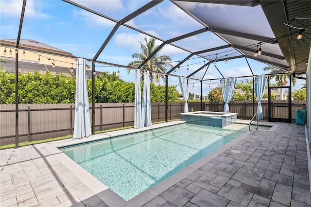 view of pool with an in ground hot tub, a patio, and glass enclosure