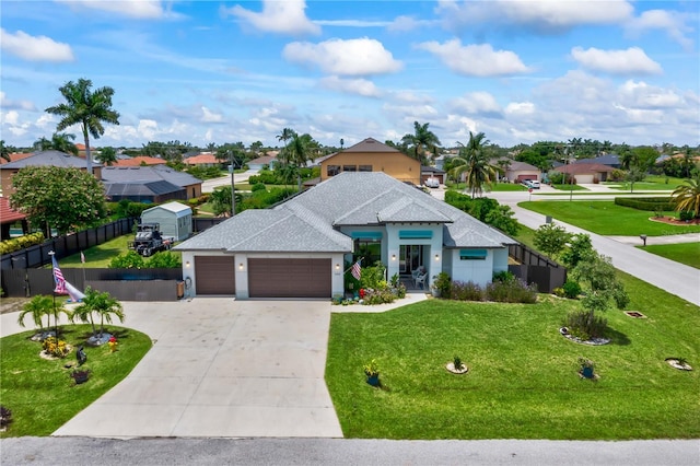 view of front of home with a garage and a front lawn