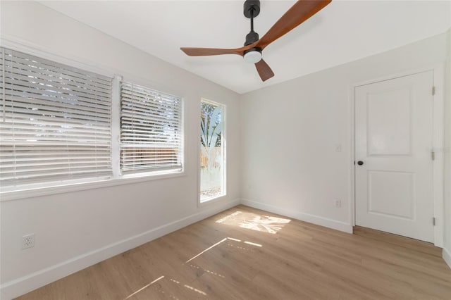 spare room with hardwood / wood-style flooring and ceiling fan