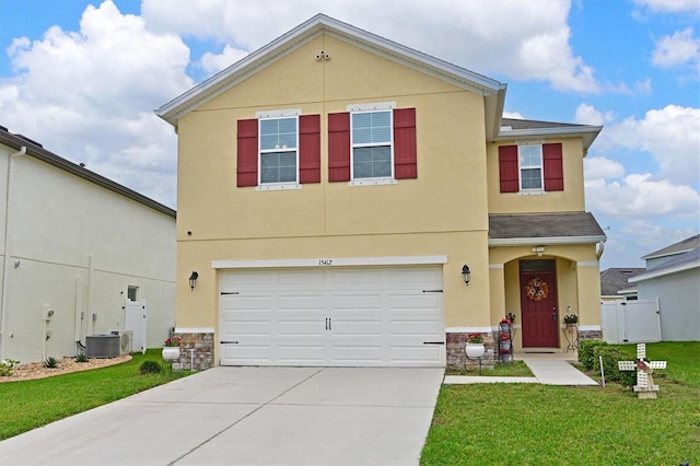 view of front of home featuring a garage, cooling unit, and a front lawn