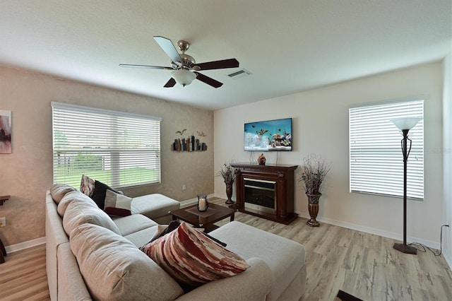 living room featuring ceiling fan and light wood-type flooring