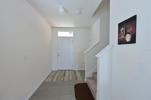 foyer with tile patterned flooring and a textured ceiling