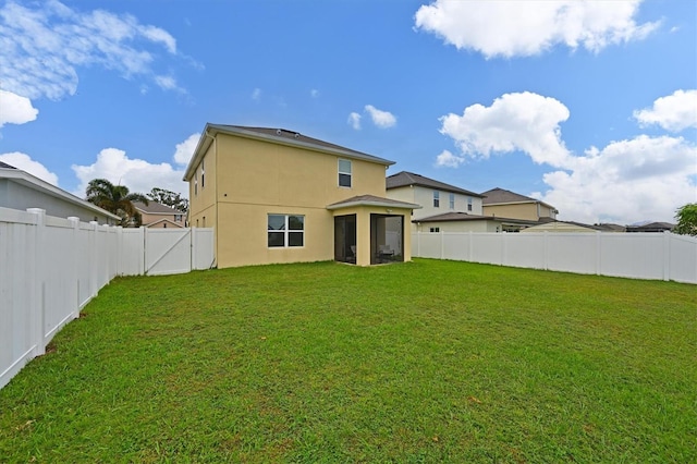 back of property with a lawn