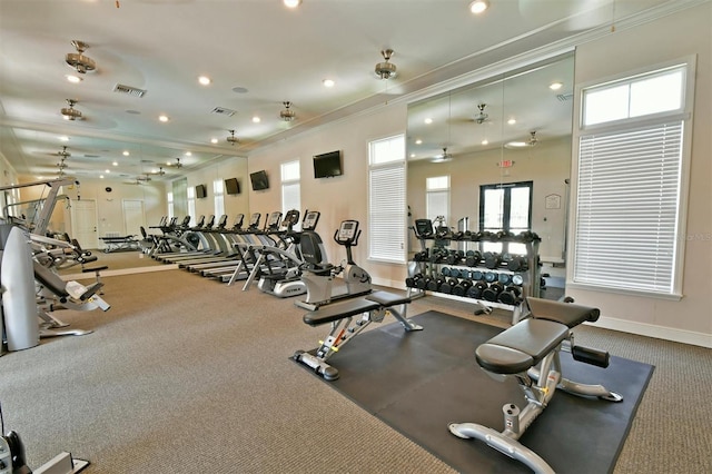 exercise room with ornamental molding and carpet floors