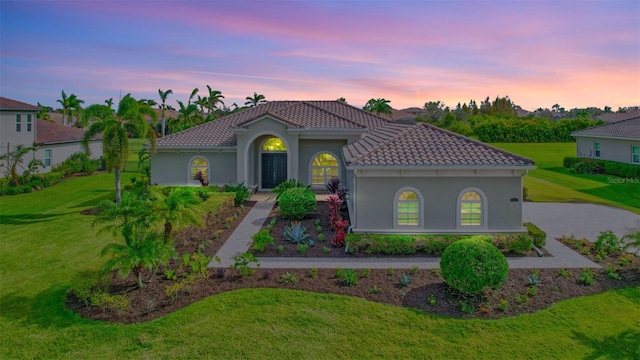 mediterranean / spanish-style home featuring a yard