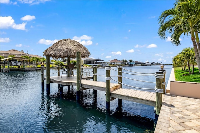 view of dock with a gazebo and a water view