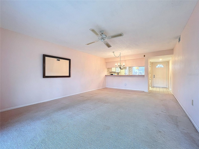 unfurnished living room featuring carpet, a textured ceiling, and ceiling fan with notable chandelier