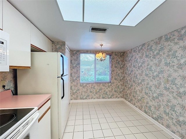 kitchen featuring white cabinetry, light tile patterned floors, an inviting chandelier, and hanging light fixtures