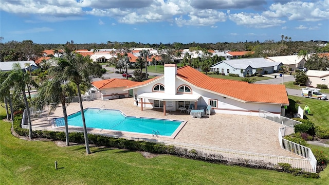 view of swimming pool with a patio area and a lawn