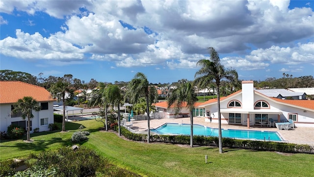 view of swimming pool with a patio and a lawn