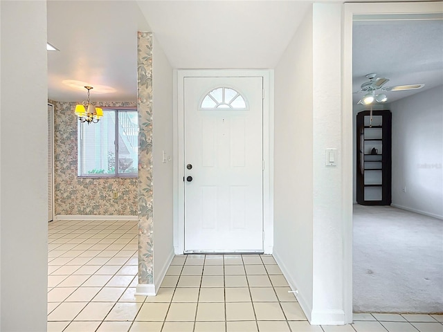 4382 Madeira Ct Unit 3361, Sarasota, FL 34233 - entryway featuring a chandelier, baseboards, light tile patterned floors, healthy amount of natural light, and wallpapered walls