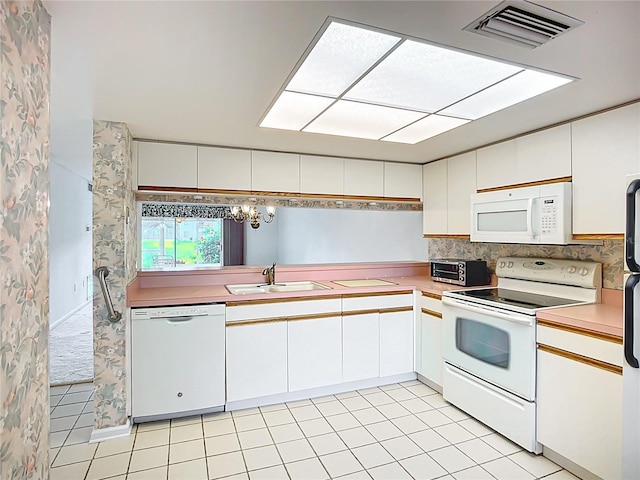 4382 Madeira Ct Unit 3361, Sarasota, FL 34233 - kitchen featuring white appliances, a sink, light countertops, and white cabinetry