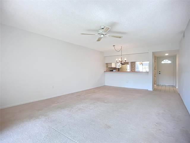 4382 Madeira Ct Unit 3361, Sarasota, FL 34233 - unfurnished living room with a chandelier, ceiling fan, light carpet, and a textured ceiling