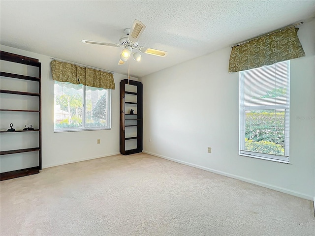 4382 Madeira Ct Unit 3361, Sarasota, FL 34233 - unfurnished room with carpet floors, ceiling fan, a textured ceiling, and baseboards
